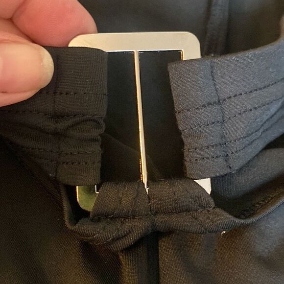 Put on black flare pants with cut out waste accent and silver accessory. Stretch - Picture 8 of 11